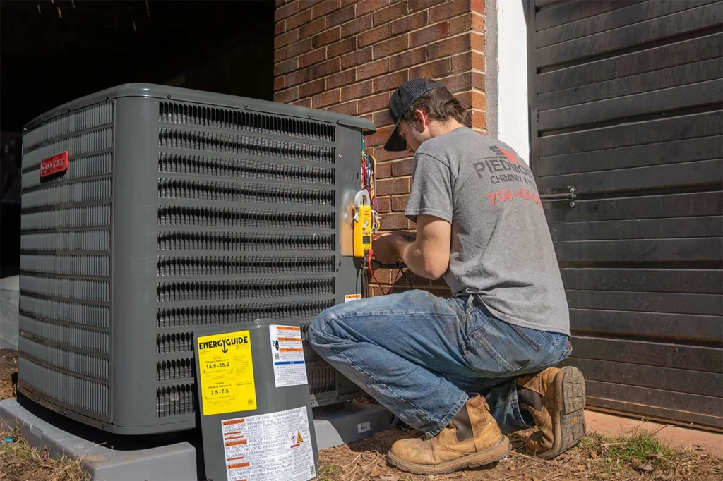 Guy fixing an AC from Piedmont HVAC, Plumbing, Chimney